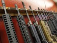 In this file photo, a row of different AR-15 style rifles are displayed for sale. The Ministry of Environment is looking to acquire similar weapons for conservation officers by April 2019.