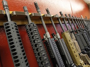 In this file photo, a row of different AR-15 style rifles are displayed for sale.