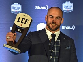 Edmonton Eskimos snapper Ryan King holds up his Tom Pate Memorial Award for contribution to his team, community and outstanding sportsmanship at the CFL Awards Gala in Edmonton on Nov. 22, 2018.