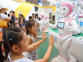 Children and families check out the latest in technology trends at the annual World Robot Conference in Beijing.
