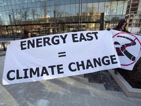 Members of Stop Energy East Halifax protest outside the library in Halifax on Monday, Jan. 26, 2015. New Brunswick Premier Blaine Higgs is hoping to persuade Quebec and Trans Canada to revive the project.