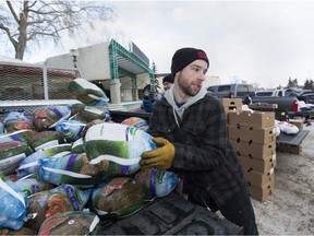 Justin Jackson is one of hundreds of helpers that hand delivered customized hampers brimming with food, gifts, a turkey and supplies to families in need  on Dec. 15, 2018, in Edmonton.