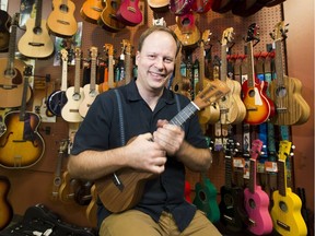 Byron Myhre from Myhre's Music plays a ukulele. The instrument has been a hot seller among beginners looking for something easier to play.