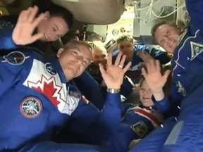 After the hatch opened, Saint-Jacques and his two crewmates floated in from the docked Soyuz capsule, embracing the astronauts who have been at the space station since June.