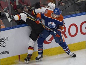 Edmonton Oilers Kyle Brodziak (28) upends Calgary Flames Mark Jankowski (77) during second period NHL action on Sunday, Dec. 9, 2018, in Edmonton.