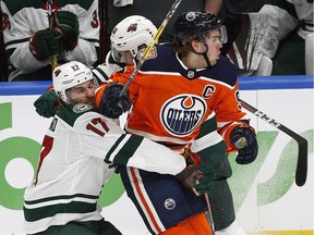 Minnesota Wild's Marcus Foligno, left, and Matt Dumba (back) try to contain Edmonton Oilers captain Connor McDavid during first period NHL hockey game action at Rogers Place on Tuesday, Oct. 30, 2018.