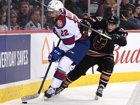 Edmonton Oil Kings defenceman Matthew Robertson fends off a Calgary Hitmen forward in WHL play in Calgary on Saturday September 29, 2018. Postmedia