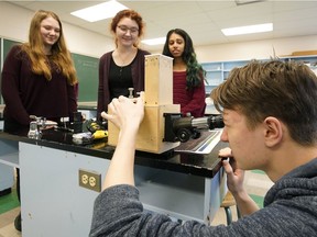 Jasper Place High School student David Dobrotvorskyy looks through a spectroscope with science and engineering club members Clara Lester, left, Alisa Lemberg and Haminah Afzal. The Association of Professional Engineers and Geoscientists of Alberta gave a $5,000 grant to the science and engineering club at Jasper Place High School in Edmonton to acquire some new equipment, including a radio telescope, spectroscope, Geiger counter, camera tracker and 3D printer.