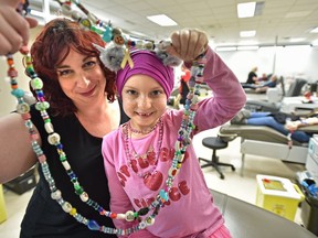 Cancer patient Nora Bazin, 7, holds her beads with her mother, Emily Bazin, on Monday, Jan. 7, 2019 after sharing her story of how blood donations have helped her through treatment and recovery. Canadian Blood Services is partnering with the Stollery  Children's Hospital for the January beaded journey campaign to encourage Edmontonians to donate blood.