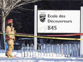 A fireman stands outside LaSalle's Ecole des Decouvreurs after the school was evacuated Jan. 14, 2019.