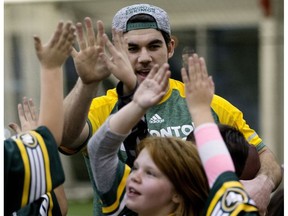 Edmonton Eskimos safety Neil King receives high-fives after a drill, as 200 children from Free Footie take part in a flag football camp put on by the club at the Commonwealth Recreation Centre, in Edmonton on Wednesday Dec. 21, 2016. Free Footie is a not-for-profit organization dedicated to ensuring kids Grades 3 to 6 can participate in sports.