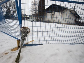 A bouquet of flowers remains at the scene of a fatal house fire at 16608 90 Ave. in Edmonton on Thursday, Jan. 3, 2019.