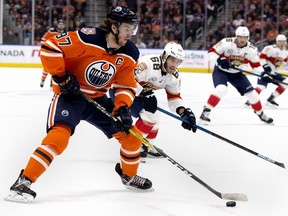 The Edmonton Oilers' Connor McDavid (97) battles the Florida Panthers' Mike Hoffman (68) during first period NHL action at Rogers Place, Thursday, Jan. 10, 2019.