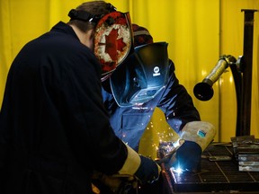 A junior high participant learns welding with a volunteer during Skills Canada Alberta's Skills Exploration Days at Edmonton Expo Centre in Edmonton, on Tuesday, Jan. 22, 2019. The program allows junior high students to try out skills which can help inform their schooling and work lives post graduation.