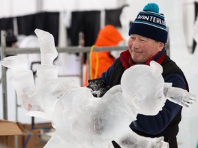 Team Sakha's Alexey Andreev works on his team's Happy Childhood ice carving on the first day of the 2019 Ice On Whyte Festival in Edmonton, on Thursday, Jan. 24, 2019.