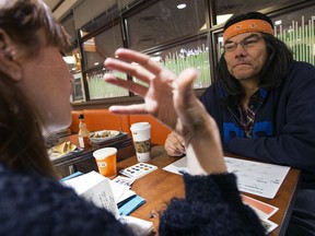 Sarah Schulman, an ethnographer with InWithForward, chats with Johnny Lee in a Whyte Avenue fast food restaurant as she gathers information for the City of Edmonton's Recover Project in Edmonton on Wednesday, Jan. 30, 2019.