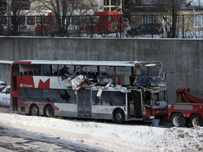 The OC Transpo bus involved in Friday's crash at Westboro Station was towed from the scene, revealing extensive damage, on Jan. 12, 2019.