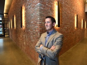 Leasing manager Sean Gerke stands next to a wall made of reclaimed brick from the 2012 demolition of the Kelly Ramsey building, inside the Raymond Block on Wednesday, Jan. 16, 2019. The mixed-use development at the corner of Whyte Avenue and 105 Street is officially opening Thursday evening.