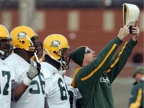 Edmonton Eskimos defensive assistant AJ Gass show the plays during practice at Commonwealth practice field.