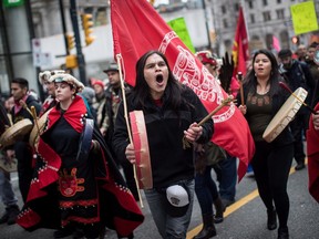 Alex Spence, centre, who is originally from Haida Gwaii, beats a drum and sings during a march in support of pipeline protesters in northwestern British Columbia, in Vancouver, on Tuesday January 8, 2019. Fourteen people were taken into custody Monday at a blockade southwest of Houston, B.C., where members of the Gidimt'en clan of the Wet'suwet'en First Nation had set up a camp to control access to a pipeline project across their territory.