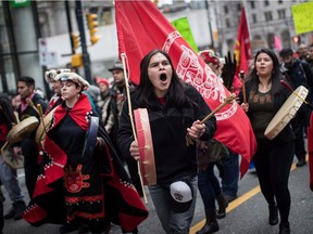 Alex Spence, centre, who is originally from Haida Gwaii, beats a drum and sings during a march in support of pipeline protesters in northwestern British Columbia, in Vancouver, on Tuesday, Jan. 8, 2019. Fourteen people were taken into custody at a blockade southwest of Houston, B.C., where members of the Gidimt'en clan of the Wet'suwet'en First Nation had set up a camp to control access to a pipeline project across their territory.