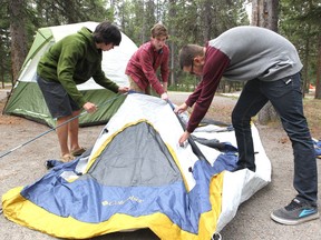 Airdrie friends, from left, Brandon Line, Connor Lengkeek and Tristan Hughes set up their campsite for a weekend of camping with friends in Banff National Park on May 17, 2013.