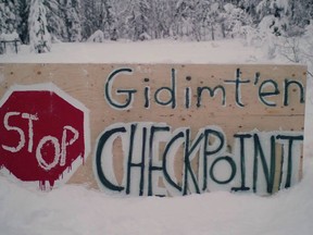 A sign for a blockade check point by the Gidimt'en clan of the Wet'suwet'en First Nation is shown in this undated handout photo posted on the Wet'suwet'en Access Point on Gidumt'en Territory Facebook page. Supporters of an Indigenous camp blocking access to a planned pipeline in northern British Columbia say they are anticipating RCMP action over an injunction filed against them. Jennifer Wickham, a member of the Gidimt'en clan of the Wet'suwet'en First Nation, said on Sunday that police have gathered in Smithers and Houston, B.C., which are the closest towns to the Gidimt'en checkpoint. TransCanada has said it has signed agreements with all First Nations along its Coastal GasLink pipeline route to LNG Canada's $40 billion liquefied natural gas project in Kitimat, B.C. But Wickham says the company does not have the authority to build through Wet'suwet'en territory because the house chiefs, who are hereditary chiefs rather than elected band council leaders, have not given consent.
