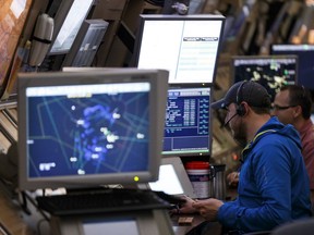 An air traffic controller is seen during the Elevate Aviation 2016 Women in Aviation Career Tour at NAV Canada's Area Control Centre at Edmonton International Airport in Nisku, Alta., on Friday March 11, 2016.