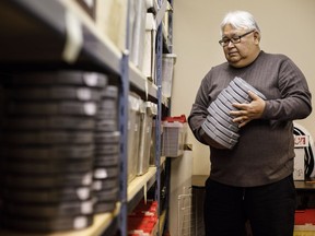 Photographer Bert Crowfoot with rolls of film in Edmonton on Saturday, Jan. 5, 2019. Crowfoot bought boxes of old audiotape and film for a dollar and has safeguarded them for decades and it's turning out to be a priceless trove of Indigenous story, culture and language.