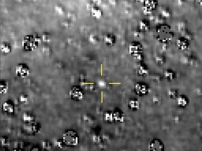 FILE - This composite image made available by NASA shows the Kuiper Belt object nicknamed "Ultima Thule," indicated by the crosshairs at center, with stars surrounding it on Aug. 16, 2018, made by the New Horizons spacecraft. The brightness of the stars was subtracted from the final image using a separate photo from September 2017, before the object itself could be detected. (NASA/Johns Hopkins University Applied Physics Laboratory/Southwest Research Institute via AP)