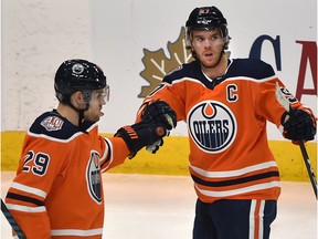 Edmonton Oilers Connor McDavid (97) celebrates his second goal with Leon Draisaitl (29) against the Calgary Flames during pre-season NHL action at Rogers Place in Edmonton, September 29, 2018.