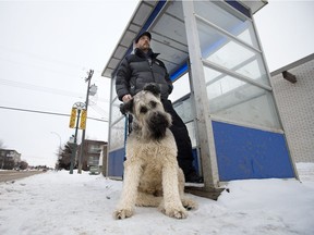 Edmonton resident Aaron Lardner and his service dog Hughie at a bus stop near 111 Avenue and 124 Street, in Edmonton Saturday Jan. 19, 2019. Lardner says he'd be the first to sign up if Edmonton had a volunteer-based snow clearing program to make certain bus stops and paths are clear.