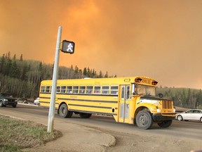 A school bus evacuating children from a school in the subdivision of Abasand drives through an intersection in Fort McMurray May 3, 2016.