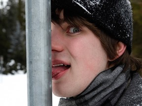 Man with tongue stuck to frozen pole