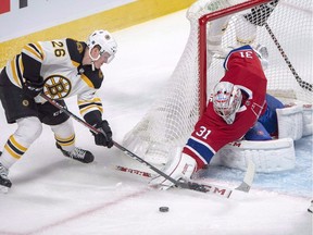 Boston Bruins centre Colby Cave (26) battles with Montreal Canadiens goaltender Carey Price (31) for a loose puck during second period NHL hockey action in Montreal on December 17, 2018. The Edmonton Oilers have claimed forward Colby Cave off waivers from the Boston Bruins.