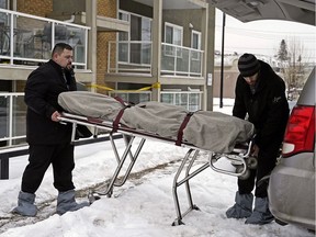 Personnel from the medical examiner's office remove a body from the Westmount Manor apartments, 11008 124 St., in Edmonton on Sunday, Jan. 6, 2019. Police homicide detectives are investigating after a man was found dead in an apartment.