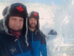 Steve Buzak from Edmonton, left, and Scott Harrison from Calgary stand by their maple leaf ice sculpture at the world's largest ice carving competition in Harbin, China. The Alberta duo placed third out of 34 teams from around the world.