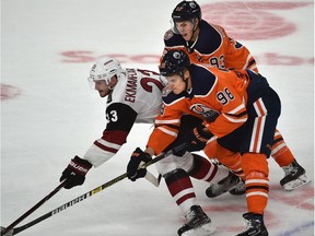 Edmonton Oilers Jesse Puljujarvi (98) and Ryan Nugent-Hopkins (93) sandwich Arizona Coyotes Oliver Ekman-Larsson during NHL preseason action at Rogers Place in Edmonton, September 27, 2018. Ed Kaiser/Postmedia