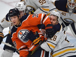 Edmonton Oilers Alex Chiasson (39) gets his elbow in the face of Buffalo Sabres Zemgus Girgensons (28) during NHL action at Rogers Place in Edmonton, January 14, 2019. Ed Kaiser/Postmedia