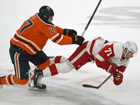 Edmonton Oilers Milan Lucic (left) checks Detroit Red Wings Dylan Larkin during second period NHL hockey game action in Edmonton on Tuesday January 22, 2019.
