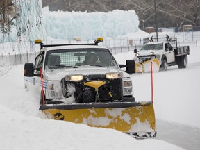 City workers remove snow from the ice at Hawrelak park on Wednesday, Jan. 30, 2019, in Edmonton.