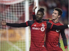 Toronto FC forward Tosaint Ricketts, left, is congratulated on his goal by teammate Jay Chapman during second half MLS soccer action against the Real Salt Lake, in Toronto, Friday, March 30, 2018.