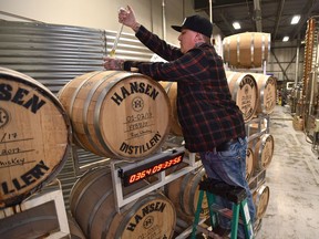 As a countdown clock reads 364 days, Kris Sustrik, distiller and co-owner of Hansen Distillery draws out whisky from a wooden barrel for tasting, as they kicked off the official 1-year countdown to the release of their Northern Eyes Whisky in Edmonton, February 11, 2019. To be called a Canadian whisky, the rye spirit must be barrel-aged for a minimum of three years. Northern Eyes Whisky will be the first single-barrel, authentic Canadian whisky to come from a local Edmonton craft producer. Ed Kaiser/Postmedia