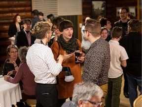 People mingle during the Edmonton Arts Council's Winter Social at the Old Timers Cabin on Monday, Feb. 11.