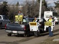 Members of the group Alberta Cash Cows warn motorists about a photo radar location along Whyte Avenue near 98 Street, in Edmonton Saturday April 29, 2017.