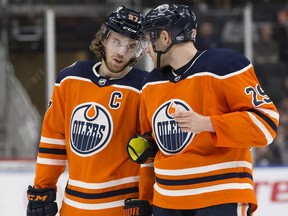 Edmonton Oilers star Connor McDavid, left, talks to teammate  Leon Draisaitl during NHL action against the Carolina Hurricanes at Rogers Place on Jan. 20, 2019.