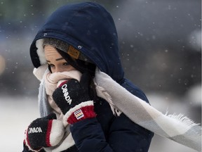 A pedestrian makes their way through the cold and snow near Jasper Avenue and 102 Street, in Edmonton Friday Feb. 1, 2019.