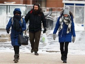 Cold pedestrians cross the street at Jasper Avenue and 112 Street in Edmonton on Tuesday, Feb. 5, 2019.