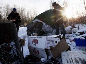 Boyle Community Services Street Outreach members Damien Lachat, left, and Doug Cooke check on the welfare of a man camping in a southeast Edmonton field, Thursday Feb. 7, 2019.