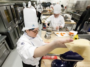 Destiny Brophy, left, and Zayne Williams from Lamont High School compete in NAIT's High School Culinary Challenge. Fifty-four students from 18 schools interested in the culinary arts experienced what being a professional cook or chef means under the guidance of NAIT's culinary arts instructors.